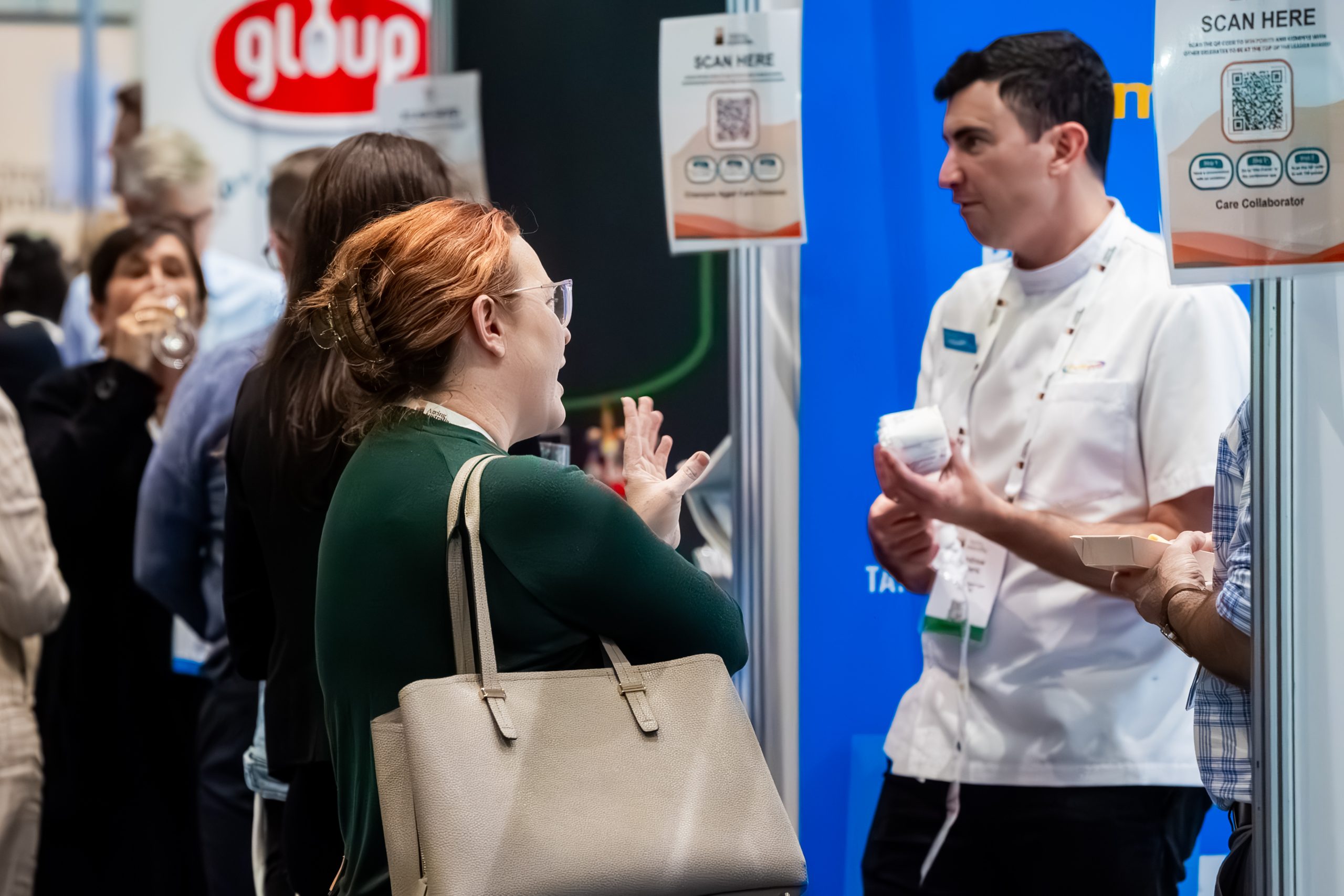 2025 QLD State Conference 2 People Speaking to an Exhibitor
